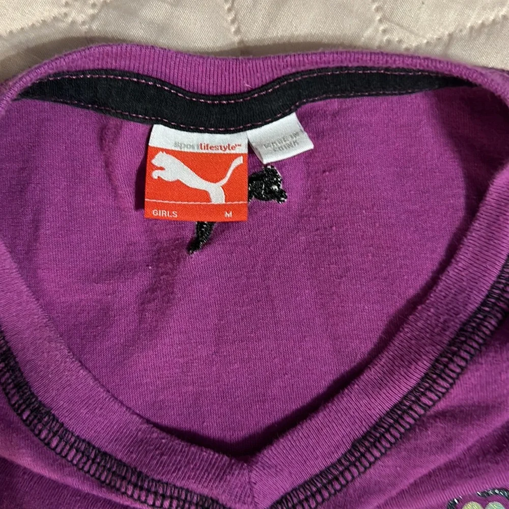 2 tee shirts and pair of shorts shirts are size girls medium. Puma and peanuts. - Picture 9 of 11